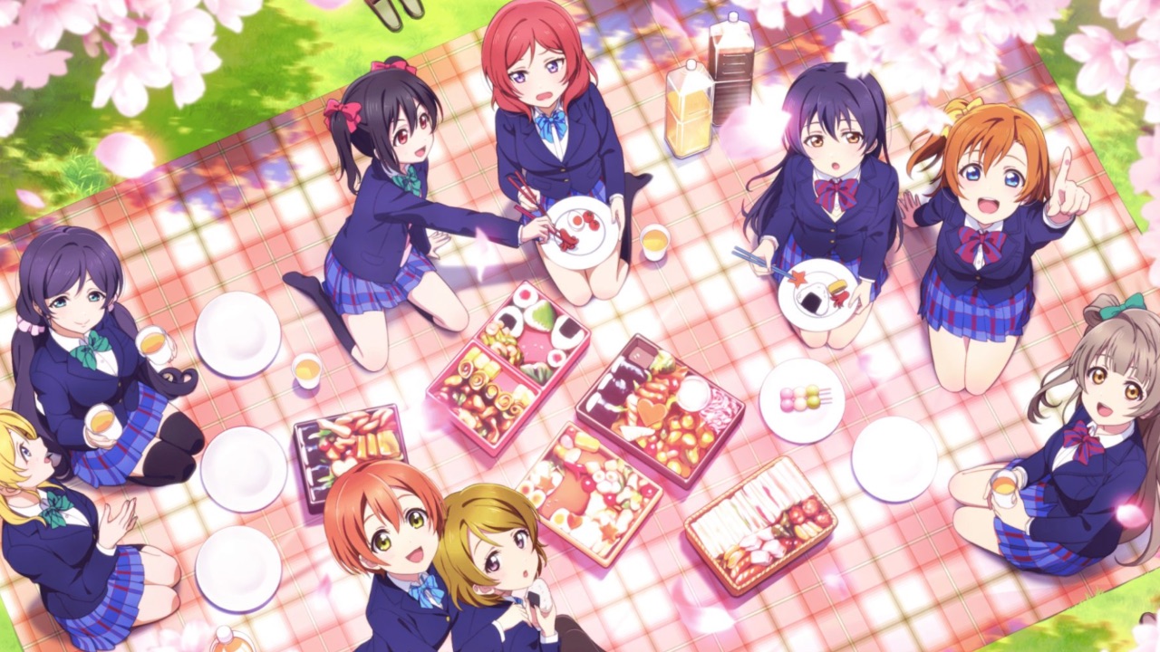 The featured image for our Love Live School Idol Festival 2 tier list, featuring a group of girls from the game looking up at the camera mid-picnic.